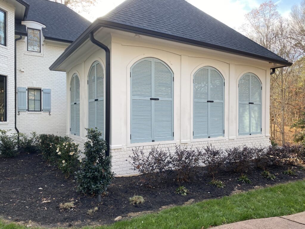 Fixed Louver Arched Shutters on a Carriage House Garage