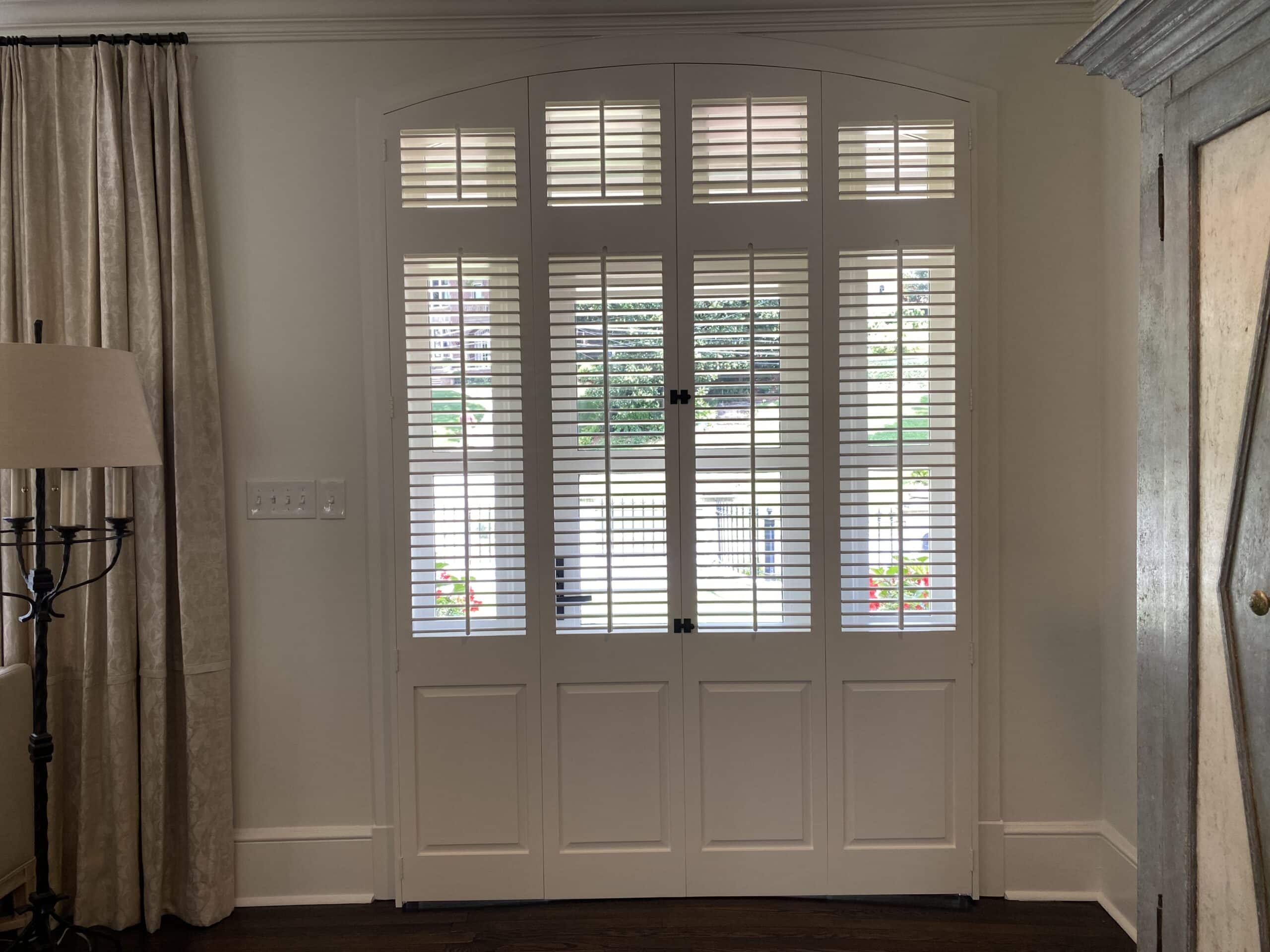 Four panel traditional louvered bi-folding shutters with raised panels
