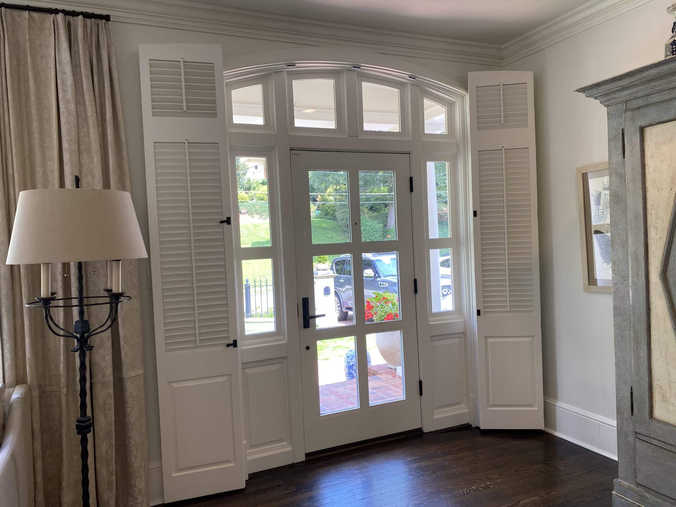 Arched entryway with functional small louver shutters